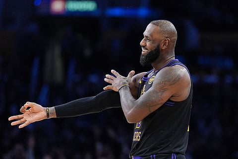 Los Angeles Lakers forward LeBron James (23) reacts to a three-point basket by guard Gabe Vincent during the second half of an NBA basketball game against the Utah Jazz in Los Angeles. 