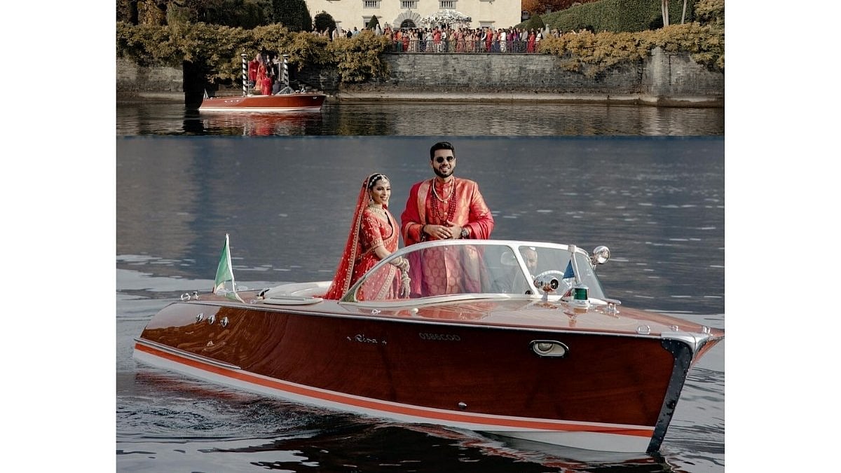 A bride and groom in wedding attire on a vintage wooden boat