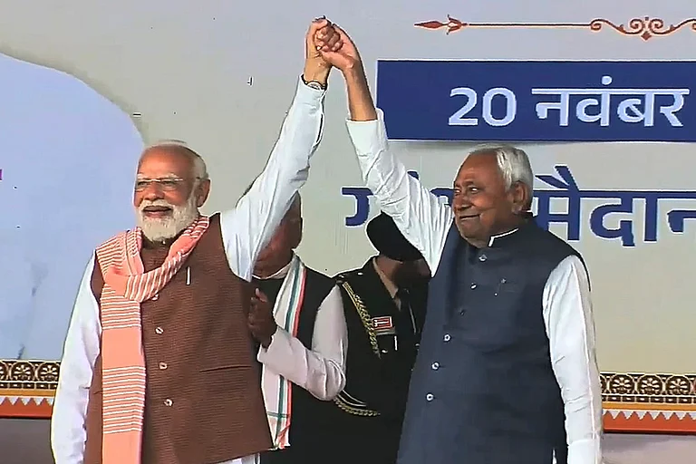 Prime Minister Narendra Modi with newly sworn-in Bihar Chief Minister Nitish Kumar during the swearing-in ceremony, at Gandhi Maidan in Patna. - | Photo: @Jduonline via PTI