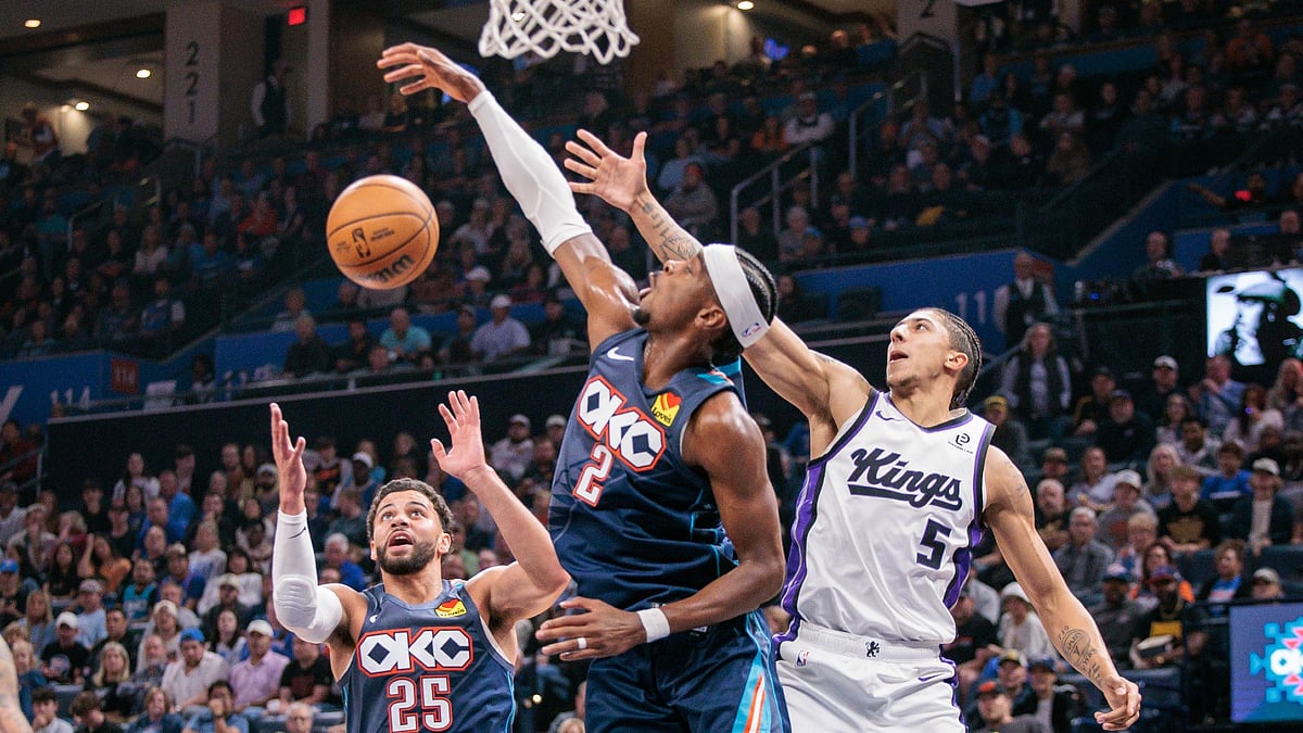 Nique Clifford #5 of the Sacramento Kings, guard Shai Gilgeous-Alexander #2 and guard Ajay Mitchell #25 of the Oklahoma City Thunder go after a rebound during the fourth quarter at Paycom Center on November 19, 2025 in Oklahoma City, Oklahoma.