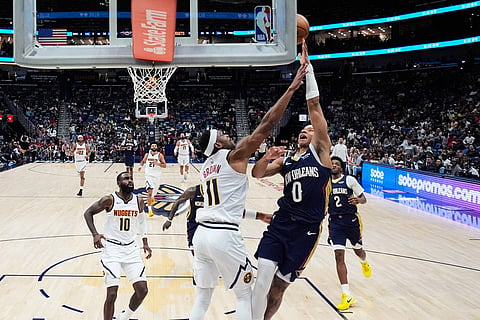New Orleans Pelicans guard Jeremiah Fears (0) goes to the basket against Denver Nuggets guard Bruce Brown (11) in the second half of an NBA basketball game in New Orleans. 