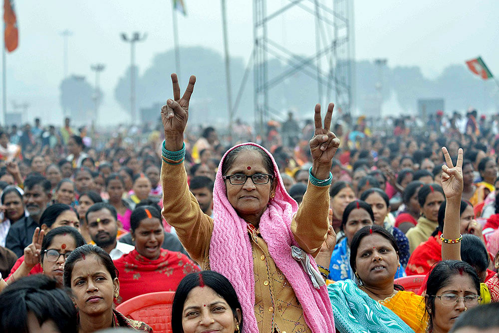 | Photo: PTI : A woman shows a victory sign at Gandhi Maidan during the swearing-in ceremony of NDA government, in Patna, Bihar.