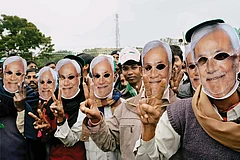 | Photo: PTI : The Loyalists: JD(U) supporters wearing masks of Nitish Kumar at a rally in Gaya