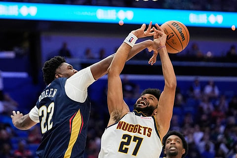 New Orleans Pelicans center Derik Queen (22) blocks a shot by Denver Nuggets guard Jamal Murray (27) in the second half of an NBA basketball game in New Orleans. 
