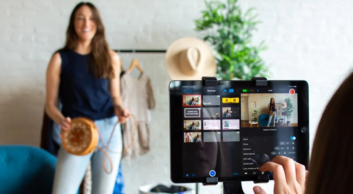 Woman modeling a round bag for a live fashion stream