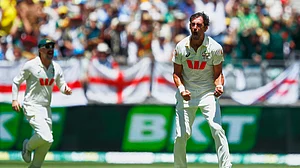 (AP Photo/Gary Day) : Australia's Mitchell Starc celebrates the wicket of England's Joe Root during the first Ashes cricket test match between Australia and England in Perth, Friday, Nov. 21, 2025.