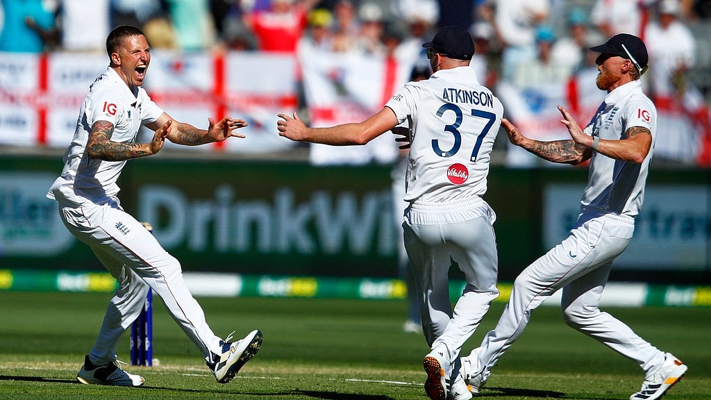 AP : England's Brydon Carse, left, celebrates with teammates Ben Stokes and Gus Atkinson the wicket of Australia's Usman Khawaja during the first Ashes Test. 