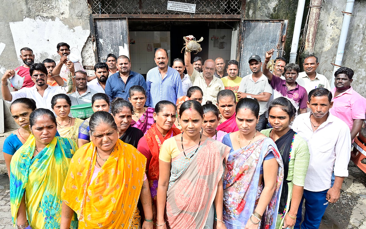 Sassoon Dock community which would be affected after godown will shut by authorities at Sassoon Dock, at Colaba on July 4, 2025 in Mumbai, India. The dispute, which is over a decade old, began after Mumbai Port Trust (MbPT) issued eviction notices alleging Maharashtra Fisheries Development Corporation (MFDC) had failed to pay lease rent. MFDC had leased the land from MbPT and sublet it to local fishermen and fish traders. The Koli community and workers involved in fish packing, export, and related trades are once again facing uncertainty and potential displacement. (Photo by Anshuman Poyrekar Hindustan Times) Koli Fisherman Community Facing Eviction From Sassoon Dock Over MFDC-MbPT Struggle