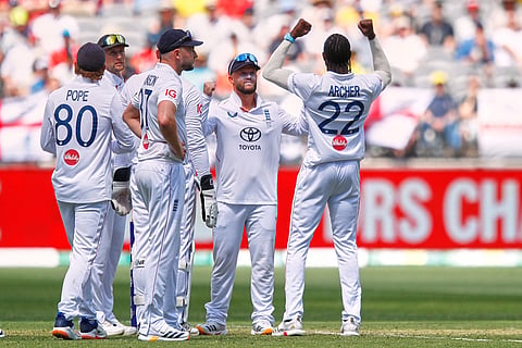 England's Jofra Archer, right, celebrates with teammates the wicket of Australia's Jake Weatherald during the first Ashes cricket test match between Australia and England in Perth.
