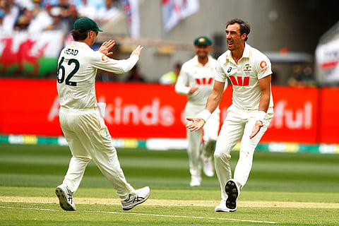 Australia's Mitchell Starc, right, celebrates with teammate Travis Head the wicket of England's Zak Crawley on day two of the first Ashes cricket test match between Australia and England in Perth.