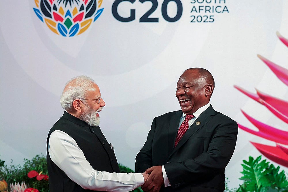 | Photo: @MEAIndia/X via PTI : Prime Minister Narendra Modi being welcomed by South African President Cyril Ramaphosa upon his arrival to attend the G20 Summit, in Johannesburg, South Africa. 