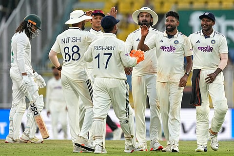 India's Mohammed Siraj, second right, celebrates with teammates after the dismissal of South Africa's Tony de Zorzi on the first day of the second cricket test match between India and South Africa in Guwahati.