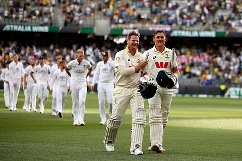 Australia's captain Steve Smith, left, and Marnus Labuschagne leave the field after winning their first Ashes cricket test match against England in Perth.