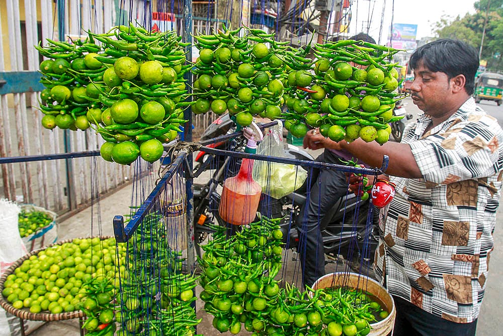 Vendor arranges Nimbu Mirchi talismans in Agartala