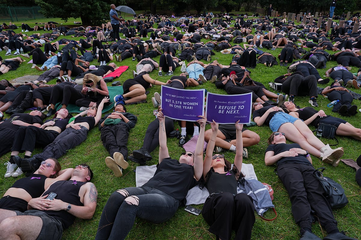 Misper Apawu : Participants hold signs while lying on the ground during a gender-based violence protest at the forecourt of the botanical gardens in Johannesburg, South Africa, Friday, Nov. 21, 2025. 