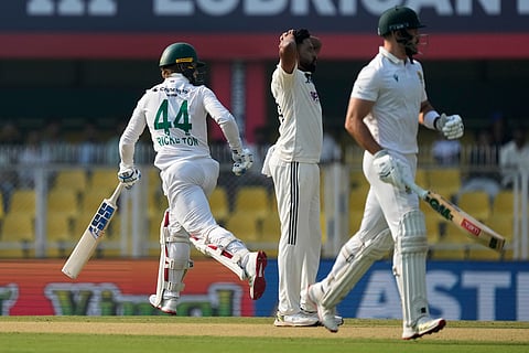 South Africa's Ryan Rickelton, left, and South Africa's Aiden Markram run between the wickets to score on the first day of the second cricket test match between India and South Africa in Guwahati.