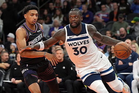 Minnesota Timberwolves forward Julius Randle (30) drives against Phoenix Suns forward Ryan Dunn during the second half of an NBA Cup basketball gam in Phoenix. 