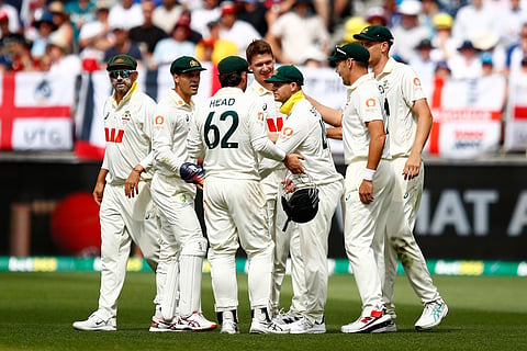 Australia's players celebrate the wicket of England's Jofra Archer on day two of the first Ashes cricket test match between Australia and England in Perth.