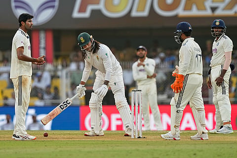 South Africa's Tony de Zorzi waits as India's players discuss for an appeal on the first day of the second cricket test match between India and South Africa in Guwahati.