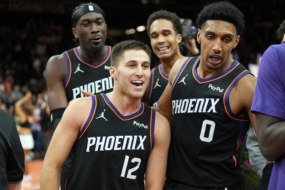 | Photo: AP/Rick Scuteri : Phoenix Suns guard Collin Gillespie (12) celebrates with teammates after hitting the winning shot against the Minnesota Timberwolves during the second half of an NBA Cup basketball game, in Phoenix. 