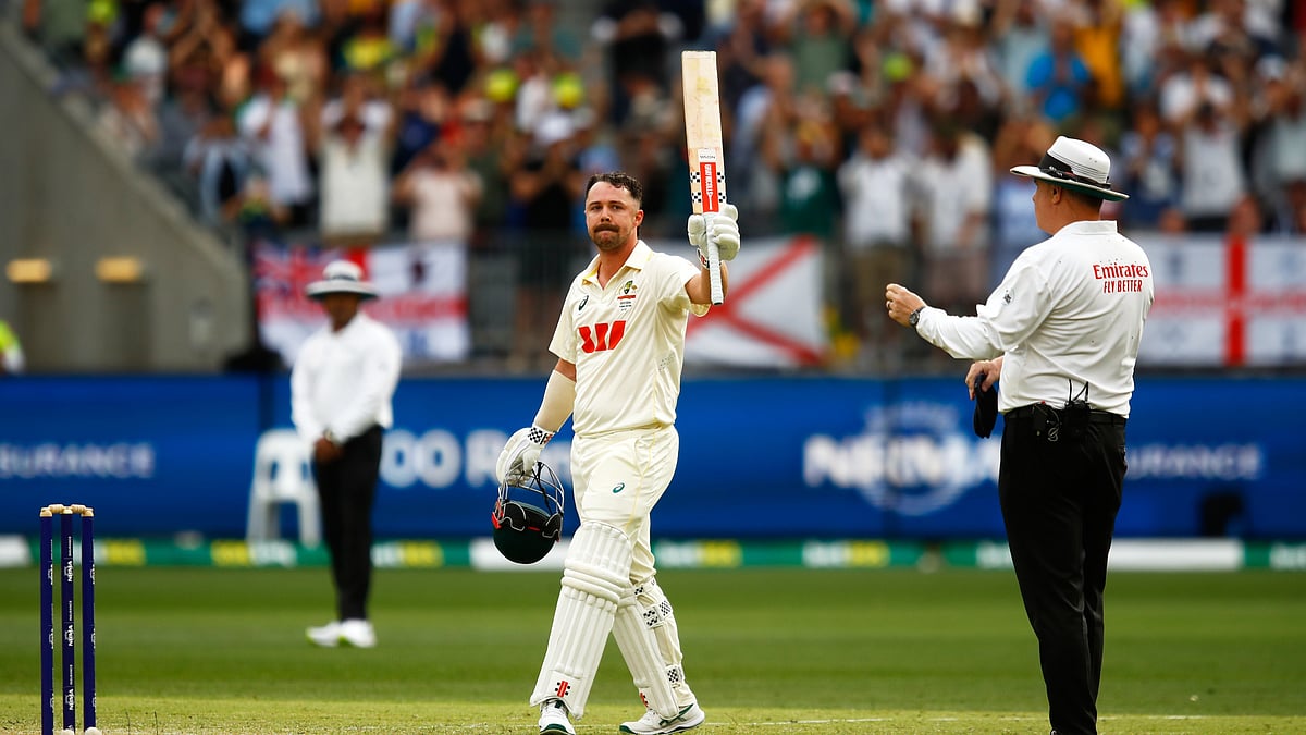 (AP Photo/Gary Day) : Australia's Travis Head celebrates his century on day two of the first Ashes cricket test match between Australia and England in Perth, Saturday, Nov. 22, 2025.