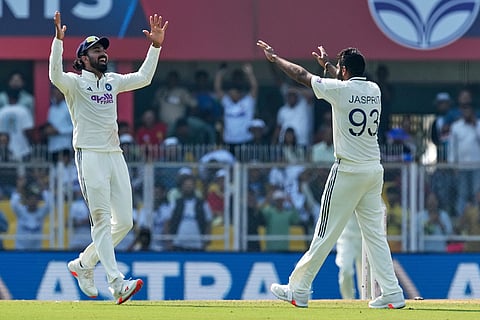 India's Jasprit Bumrah, right, celebrates the dismissal of South Africa's Aiden Markram with team mate India's KL Rahul on the first day of the second cricket test match between India and South Africa in Guwahati.