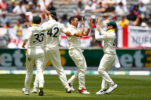 Australia's Scott Boland, second right, celebrates with captain Steve Smith the wicket of England's Ben Duckett on day two of the first Ashes cricket test match between Australia and England in Perth.