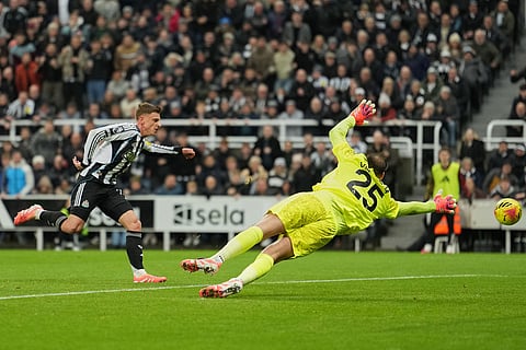 Newcastle's Harvey Barnes misses by Manchester City's goalkeeper Gianluigi Donnarumma during a Premier League soccer match between Newcastle United and Manchester City in Newcastle, England.