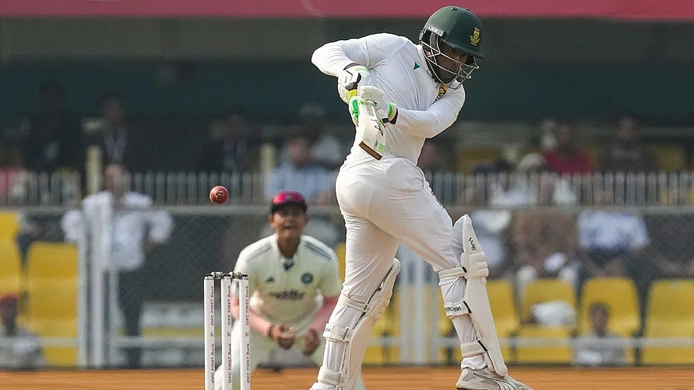 Photo: PTI/Shahbaz Khan : South Africa's Senuran Muthusamy plays a shot during the day two of the second Test cricket match of a series between India and South Africa, at ACA Stadium in Guwahati.