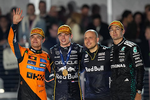 From left, second place finisher McLaren driver Lando Norris of Great Britain, first place finisher Red Bull driver Max Verstappen of the Netherlands, Verstappen's chief race engineer Gianpiero Lambiase, and third place finisher Mercedes driver George Russell of Great Britain celebrate after the Formula One Las Vegas Grand Prix auto race in Las Vegas. 