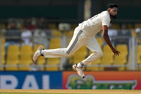 India's Mohammed Siraj bowls a delivery on the second day of the second cricket test match between India and South Africa in Guwahati.