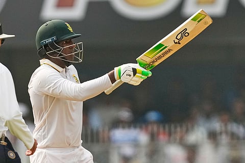 South Africa's Senuran Muthusamy celebrates after scoring fifty runs on the second day of the second cricket test match between India and South Africa in Guwahati.