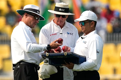 Umpires check balls before change during the second day of the second cricket test match between India and South Africa in Guwahati.