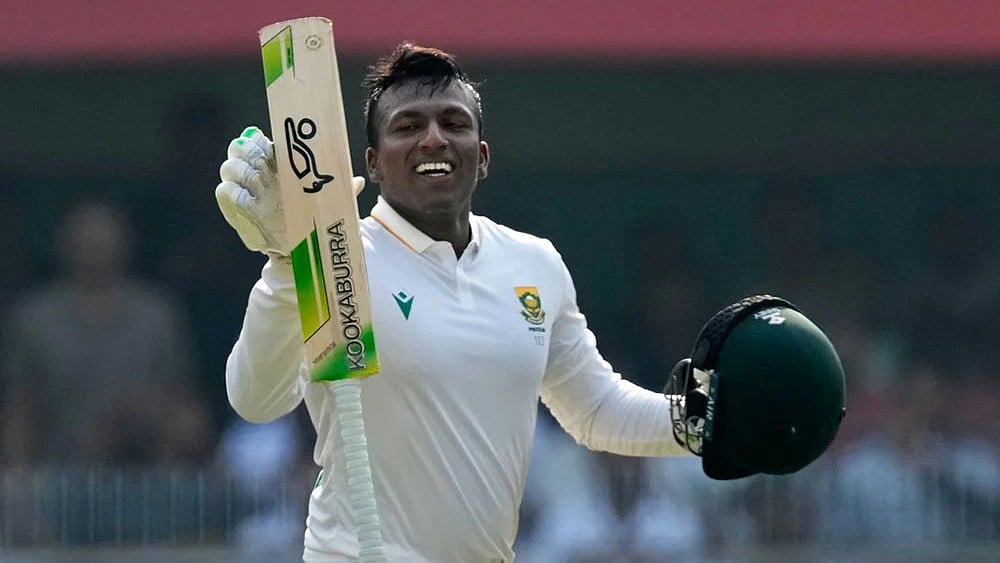 Photo: AP/Anupam Nath : South Africa's Senuran Muthusamy celebrates after scoring a century on the second day of the second cricket test match between India and South Africa in Guwahati.