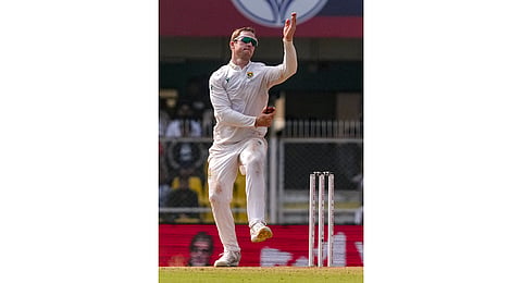 South Africa's Simon Harmer bowls during day three of the second Test cricket match between India and South Africa, at ACA Stadium in Guwahati.