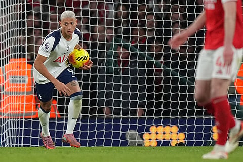 Tottenham's Richarlison brings the ball back to the center after scoring during a Premier League soccer match between Arsenal and Tottenham in London.