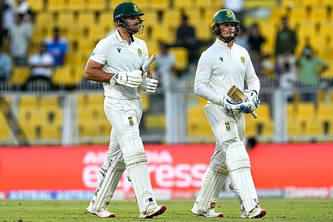 South Africa's Aiden Markram and South Africa's Ryan Rickelton walk off the field at the end of the third day of the second cricket test match between India and South Africa in Guwahati.