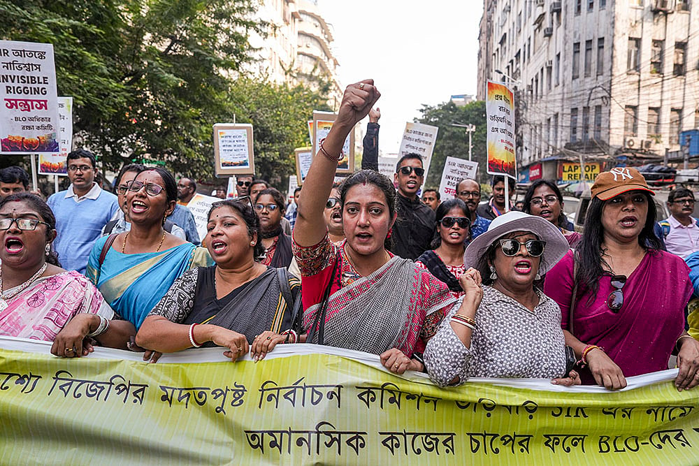 | Photo: PTI/Swapan Mahapatra : Booth level officers who are engaged in the ongoing special intensive revision (SIR) of electoral rolls in West Bengal raise slogans during a protest march to the office of the Chief Electoral Officer (CEO over alleged excessive work pressure, in Kolkata.
