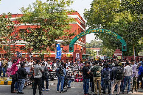 People participate in a protest by school students and parents of a Class 10 student, who allegedly died by suicide due to mental harassment, demanding strict action against those responsible, outside St Columba's School, in New Delhi.