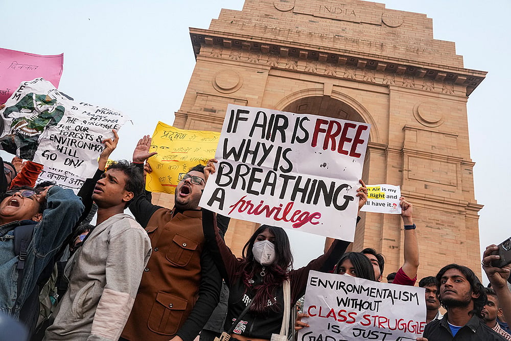 Photo: PTI/Karma Bhutia : People raise slogans during a protest against worsening air quality in the national capital, at the India Gate, in New Delhi. The air quality remained in the "very poor" category on Sunday morning, with the overall Air Quality Index (AQI) recorded at 381, according to the Central Pollution Control Board (CPCB). 