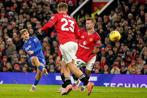 Everton's Kiernan Dewsbury-Hall, left, scores the opening goal during the English Premier League soccer match between Manchester United and Everton in Manchester, England.