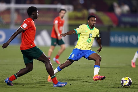 Brazil's Gabriel Mec fights for the ball against Portugal's Daniel Banjaqui during the FIFA U17 World Cup semifinal soccer match between Portugal and Brazil in Doha, Qatar.