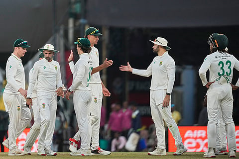 South Africa's players celebrate at the end of the fourth day of the second cricket test match between India and South Africa in Guwahati.
