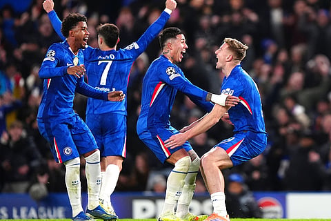 Chelsea's Liam Delap, right, celebrates scoring his side's third goal of the game with teammates during the Champions League opening phase soccer match between Chelsea and Barcelona in London, England.