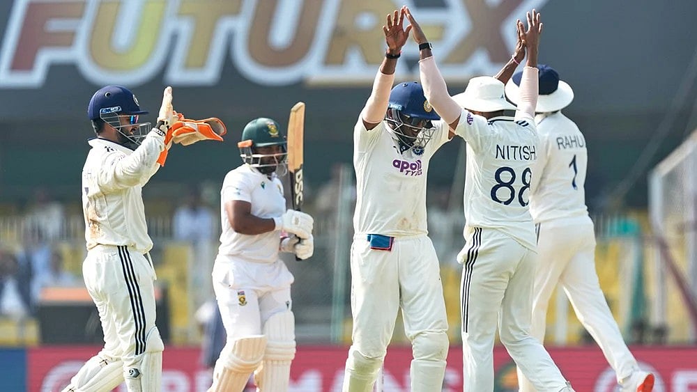 | Photo: AP/Anupam Nath : India's players celebrate the dismissal of South Africa's captain Temba Bavuma, second left, on the fourth day of the second cricket test match between India and South Africa in Guwahati.