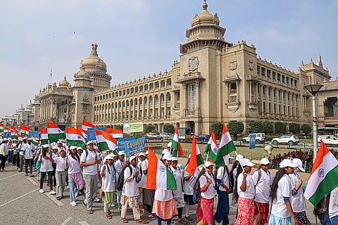 Students hold the national flag during a rally marking the Constitution Day celebrations, at Vidhana Soudha, in Bengaluru.