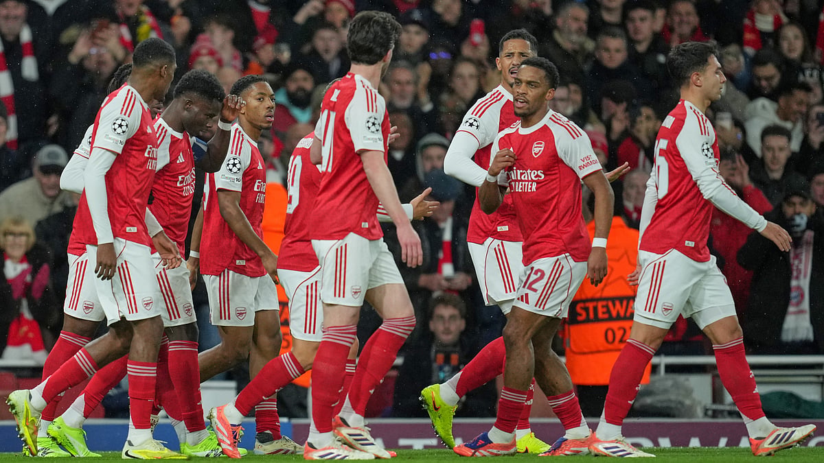 Arsenal's Jurrien Timber celebrates with teammates after scoring the opening goal during the UEFA Champions League opening phase match against Bayern Munich on November 26, 2025. - | Photo: AP/Kin Cheung