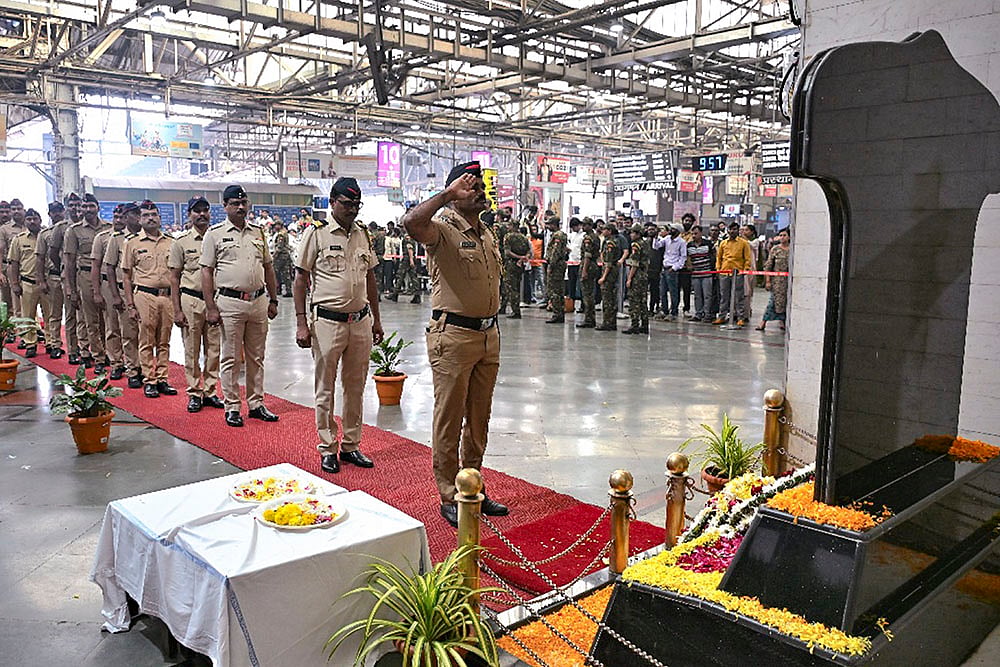 | Photo:  PTI : Police personnel pay tribute to the victims of the 26/11 Mumbai terror attack on the attack's 17th anniversary, at Chhatrapati Shivaji Maharaj Terminus (CSMT) in Mumbai.
