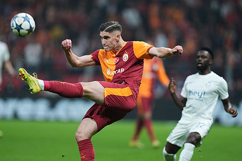 Galatasaray's Roland Sallai, left, clears the ball during the Champions League opening phase soccer match between Galatasaray and Union Saint-Gilloise, in Istanbul, Turkey.