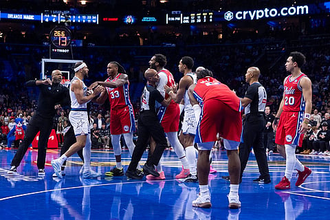 An incident on the court between Orlando Magic's Jalen Suggs, second from left, Philadelphia 76ers' Jabari Walker, third from right, and Andre Drummond, center, which leads to technicals and the ejection of Suggs during the first half of an NBA Cup basketball game in Philadelphia.